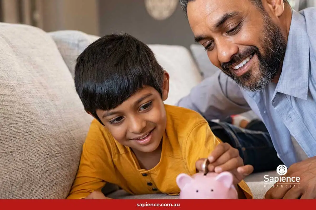 father and son with pink piggybank